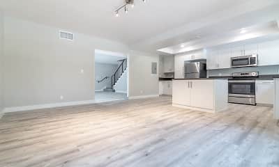 kitchen with a kitchen island, refrigerator, stainless steel microwave, range oven, white cabinetry, and light parquet floors, Bixby Hill Manor, 2