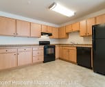 kitchen with range oven, refrigerator, extractor fan, dishwasher, light countertops, light tile floors, and light brown cabinets, Woodland Estates