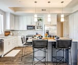 kitchen with natural light, stainless steel appliances, white cabinetry, light hardwood floors, pendant lighting, and light granite-like countertops, The Jackson at Viridian