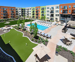 view of property featuring a lawn and a pool, The Mill at Ironworks Plaza