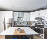 kitchen with electric range oven, stainless steel appliances, light countertops, white cabinetry, pendant lighting, and light parquet floors, Notch 8