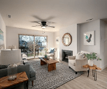 living room featuring a ceiling fan, hardwood flooring, a fireplace, and natural light, Avenue View Apartments