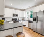kitchen featuring natural light, a breakfast bar, stainless steel appliances, range oven, white cabinetry, dark countertops, and light hardwood floors, Myrtle Landing Townhomes