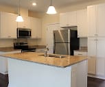 kitchen featuring a center island, electric range oven, stainless steel appliances, granite-like countertops, white cabinets, pendant lighting, and dark hardwood floors, River Oaks Village