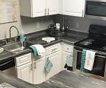 kitchen with microwave, dishwasher, refrigerator, electric range oven, dark countertops, and white cabinets, Welby Park Estates