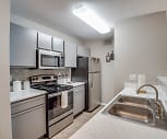 kitchen with stainless steel microwave, refrigerator, electric range oven, white cabinets, light countertops, and light hardwood flooring, The Park At Spring Creek