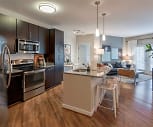 kitchen featuring electric range oven, stainless steel appliances, dark brown cabinetry, light granite-like countertops, pendant lighting, and dark parquet floors, The Porter Del Ray