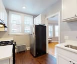 kitchen featuring a wealth of natural light, exhaust hood, refrigerator, radiator, gas range oven, dark hardwood floors, white cabinets, and light countertops, 173-181 N. Grove Avenue