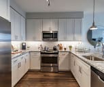 kitchen with stainless steel appliances, range oven, dark parquet floors, light stone countertops, white cabinetry, and pendant lighting, Canvas