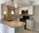 kitchen with a center island, stainless steel microwave, refrigerator, electric range oven, white cabinets, light tile floors, pendant lighting, and light stone countertops, Aventura Orlando Apartments