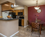 kitchen with range oven, refrigerator, microwave, dark stone countertops, light tile flooring, and brown cabinetry, Riverwalk Apartments