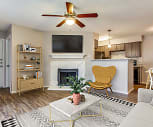 living room featuring a ceiling fan, hardwood floors, a fireplace, refrigerator, and TV, Copper Crossing