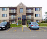 view of building exterior featuring a yard, Stonecreek Apartments