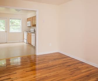 wood floored spare room featuring natural light, microwave, and range oven, Kentwood Village