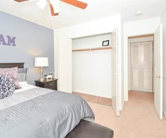 carpeted bedroom featuring a ceiling fan, The Retreat on 6th
