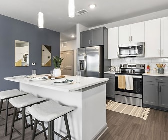 kitchen featuring a kitchen bar, electric range oven, stainless steel appliances, white cabinetry, light countertops, pendant lighting, and dark floors, Overlook Point