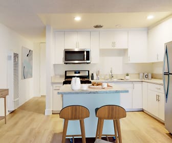 kitchen featuring stainless steel appliances, range oven, light hardwood flooring, white cabinets, and light countertops, Mediterranean Village
