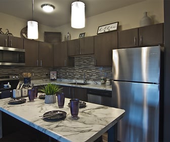 kitchen featuring stainless steel appliances, range oven, light countertops, pendant lighting, and dark brown cabinets, Park West 205