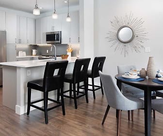 kitchen with a breakfast bar, stainless steel appliances, pendant lighting, white cabinets, light countertops, and light parquet floors, Avalon Sudbury
