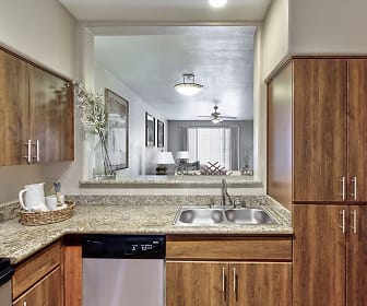 kitchen with a ceiling fan, stainless steel dishwasher, microwave, and brown cabinetry, Camden Montierra