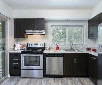kitchen with plenty of natural light, electric range oven, refrigerator, extractor fan, stainless steel dishwasher, light hardwood floors, dark brown cabinets, and light stone countertops, Top Field Apartments
