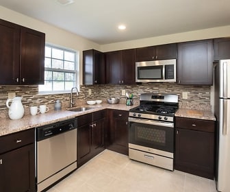 kitchen featuring natural light, stainless steel appliances, gas range oven, light tile floors, dark brown cabinetry, and light granite-like countertops, Lamberts Mill Village