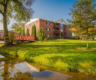 surrounding community featuring a large lawn and a water view, Creek Club Apartments