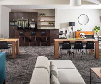 living room featuring a breakfast bar area, oven, refrigerator, and microwave, River Park by Broadmoor