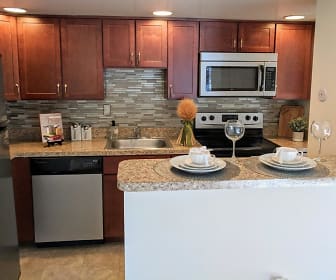 kitchen featuring stainless steel appliances, range oven, dark brown cabinetry, light granite-like countertops, and light tile floors, Waterview Apartments