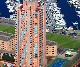 view of building exterior featuring a lawn, Harbor Tower Apartments