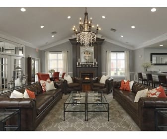 living room featuring a fireplace, a chandelier, vaulted ceiling, and natural light, Ashford Meadows