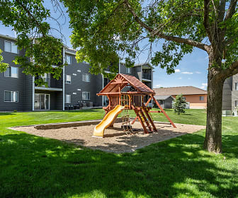 view of jungle gym featuring a large lawn, Prairie Winds Apartments