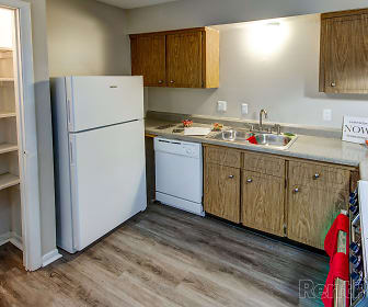 kitchen with refrigerator, dishwasher, brown cabinetry, and light parquet floors, The Sycamores