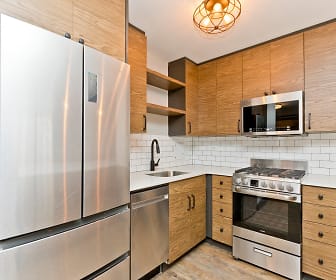 kitchen featuring gas range oven, stainless steel appliances, light countertops, pendant lighting, brown cabinets, and light parquet floors, 512 Wrightwood