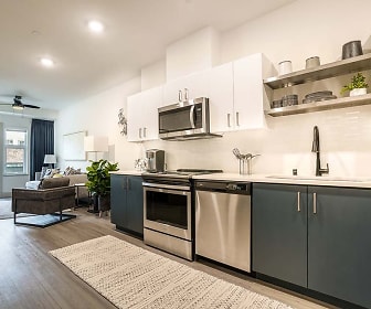 kitchen with a ceiling fan, stainless steel appliances, range oven, light hardwood floors, white cabinets, and light countertops, The Press Apartments