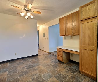 kitchen with a ceiling fan, refrigerator, dark tile flooring, brown cabinets, and light countertops, Parkwest Gardens