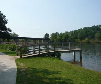 view of dock featuring a water view and an expansive lawn, Shoreview Apartments