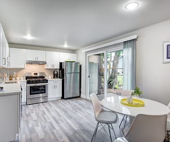 kitchen featuring gas range oven, stainless steel refrigerator, fume extractor, light floors, light countertops, and white cabinets, Timbre Apartments
