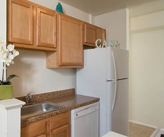 kitchen featuring refrigerator, dishwasher, light floors, and brown cabinetry, Hillcrest Village