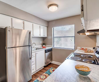 kitchen featuring natural light, stainless steel refrigerator, dishwasher, white cabinetry, light parquet floors, and light countertops, Cypress Pointe