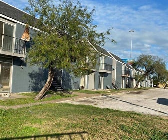 view of front of property with a water view and an expansive front lawn, Coastal Pointe Apartments