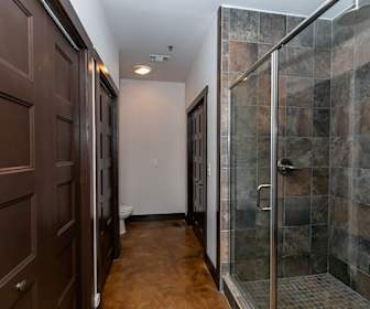 bathroom with tile flooring, shower booth, and toilet, The Lofts at Swift Mill