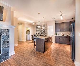 kitchen featuring a fireplace, refrigerator, dishwasher, TV, dark brown cabinets, pendant lighting, light parquet floors, and light countertops, Olympus Encantada