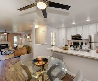 kitchen featuring a ceiling fan, a fireplace, natural light, stainless steel appliances, range oven, light granite-like countertops, white cabinetry, and dark hardwood flooring, The Brighton