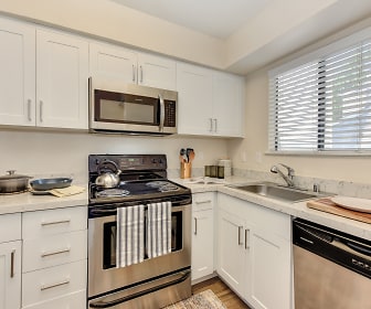 kitchen featuring natural light, electric range oven, stainless steel appliances, light floors, light countertops, and white cabinetry, Silverstone