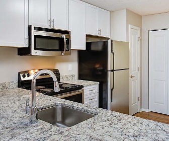 kitchen with refrigerator, electric range oven, stainless steel microwave, white cabinetry, light parquet floors, and light granite-like countertops, Burke Shire Commons Apartments