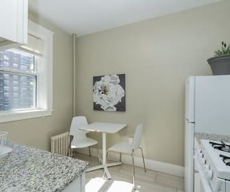 kitchen featuring natural light, radiator, light floors, and light stone countertops, The Baldwin