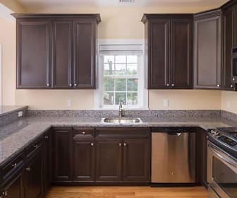 kitchen featuring natural light, stainless steel appliances, gas range oven, stone countertops, pendant lighting, dark brown cabinets, and light flooring, Riverfront At Cranford