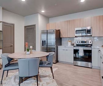 kitchen featuring stainless steel appliances, range oven, light brown cabinetry, light countertops, and light parquet floors, Azure
