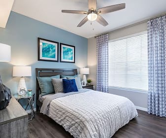 bedroom featuring a ceiling fan and natural light, The Arbors at Carrollwood Apartments